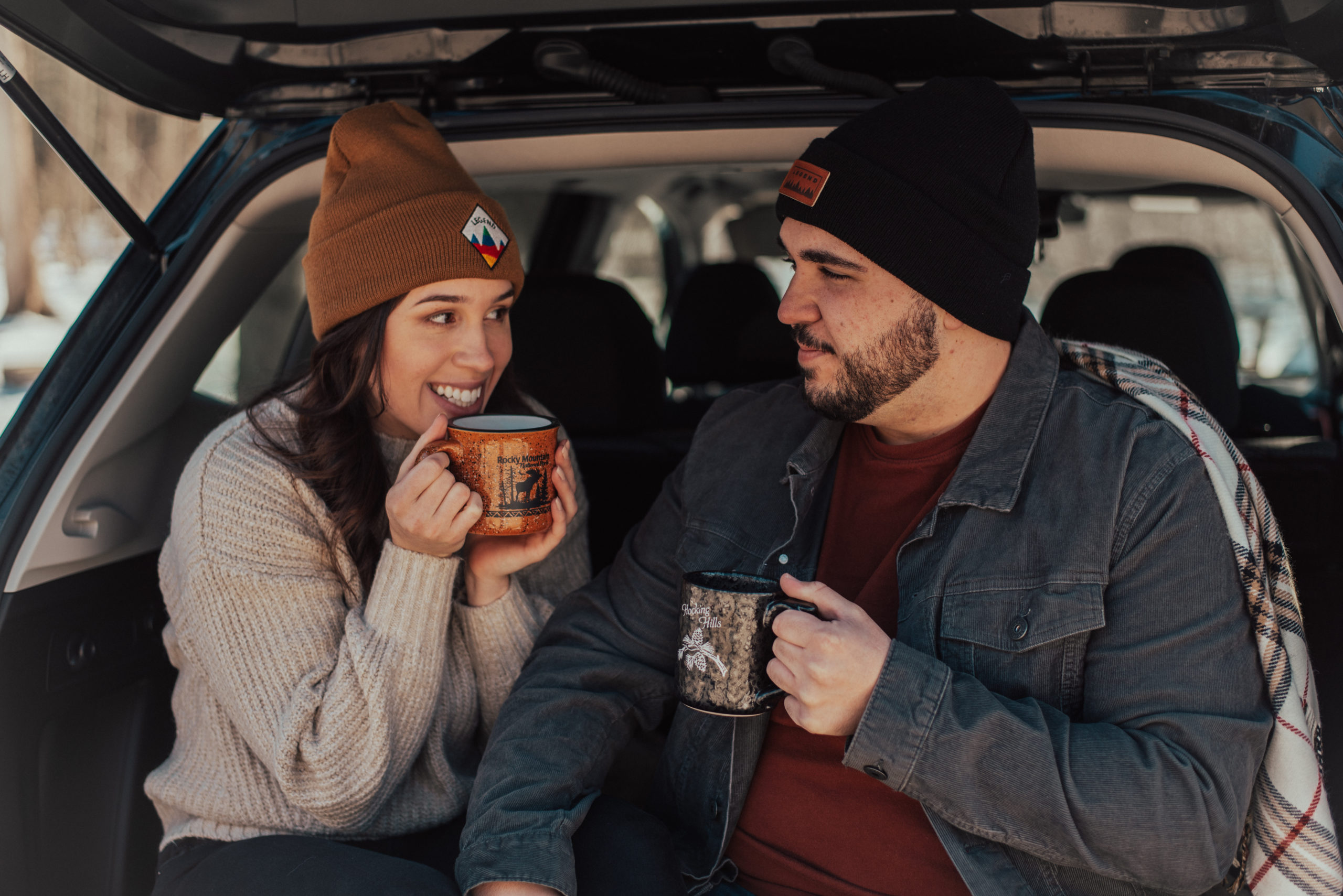 Couple in a car drinking hot coco