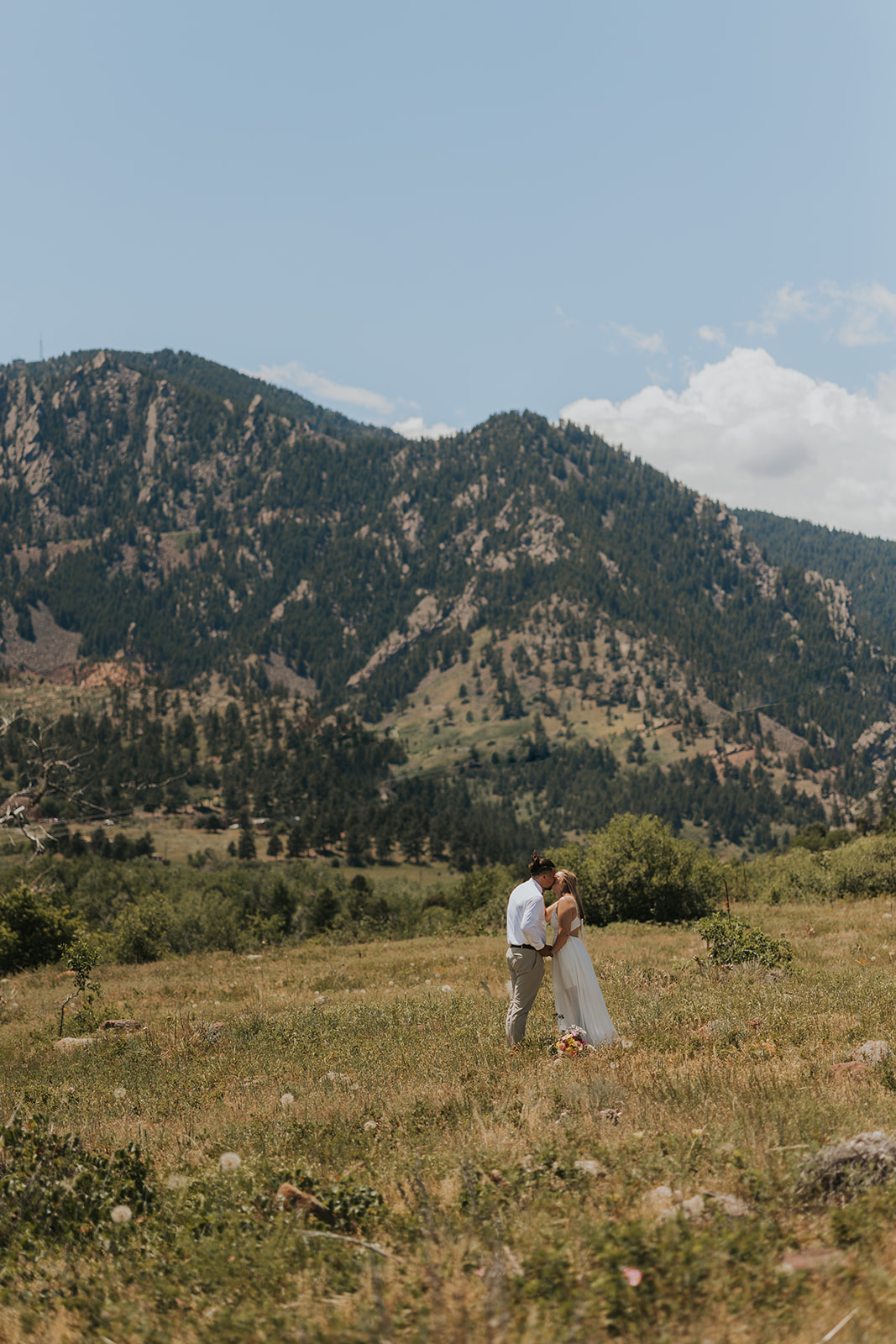 couple standing in front of a mountain during their elopement