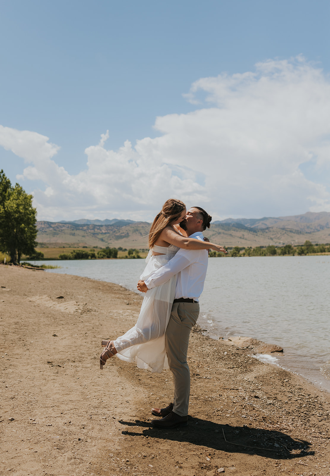 couple kissing by a lake during their elopement Why You Might Need a Permit For Your National Park Pictures