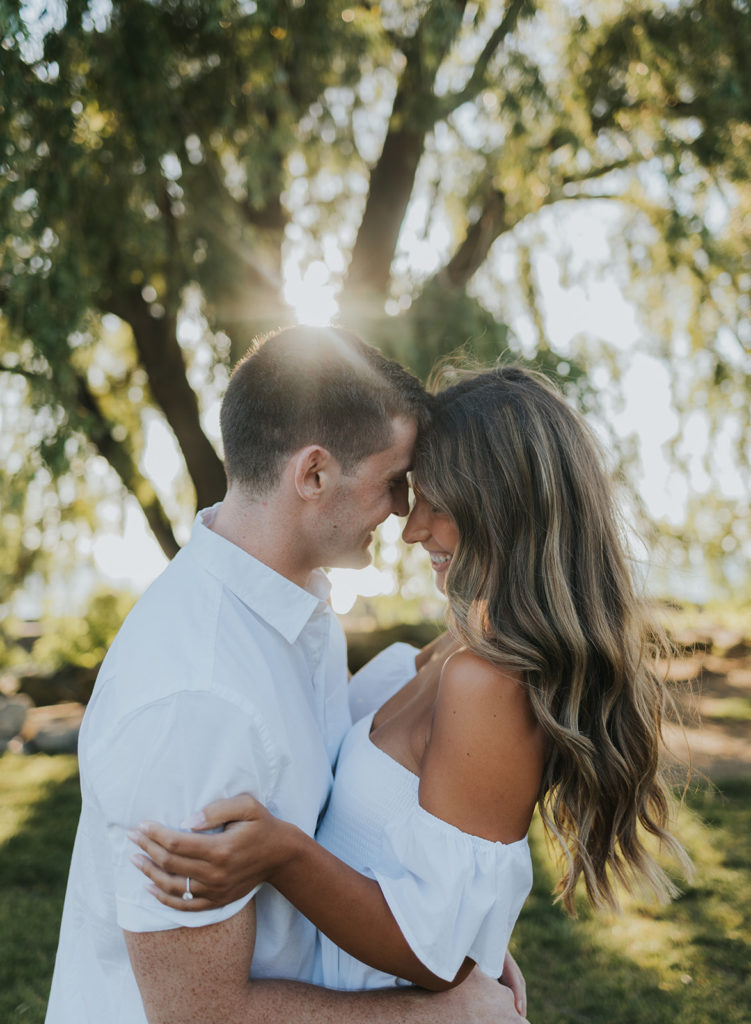 Couple smiling at eachother during engagement photoshoot