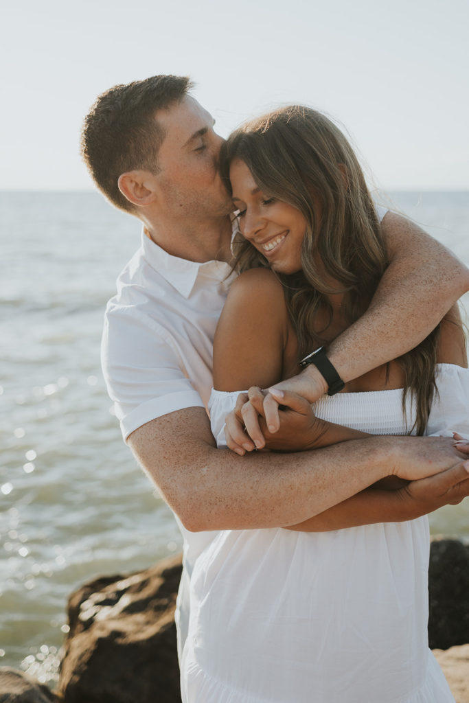 Couple kissing and smiling for photoshoot