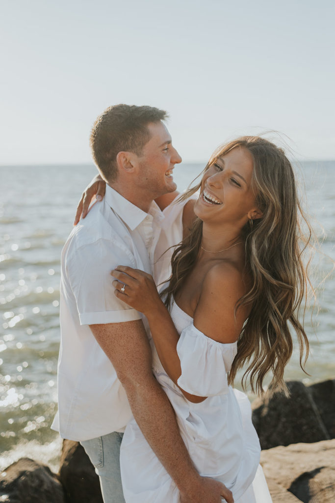 Couple laughing during photoshoot on the beach