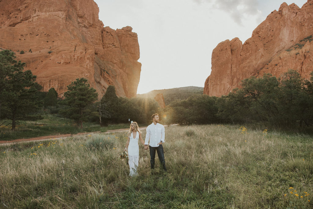 Newly wed couple posing in front of Colorado mountains for elopement photos 
