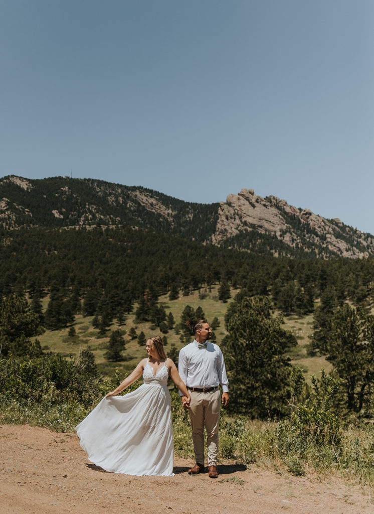 Couple posing in front of the mountains for photoshoot