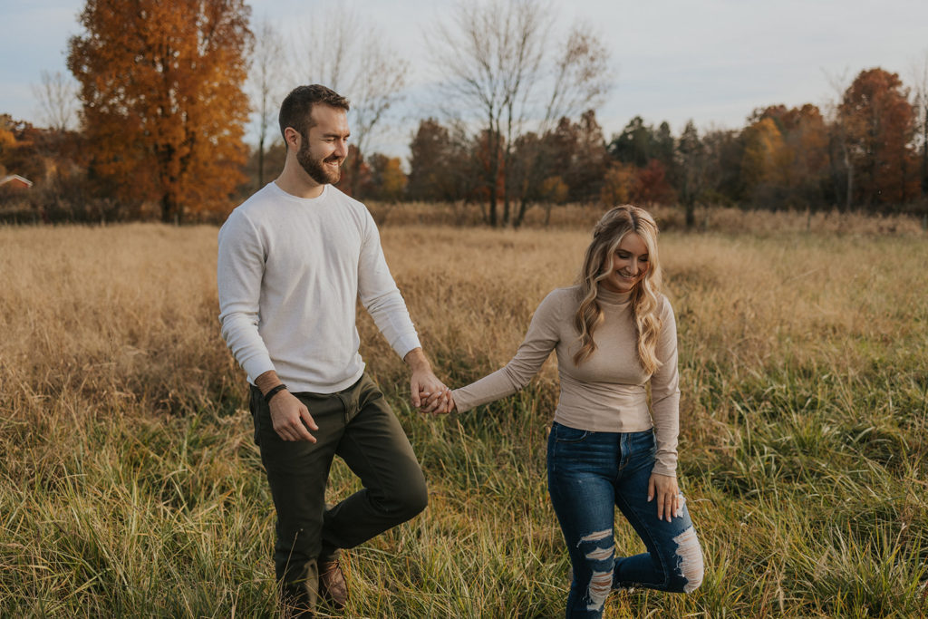 Newly engaged couple holding hands for Ohio engagement photoshoot