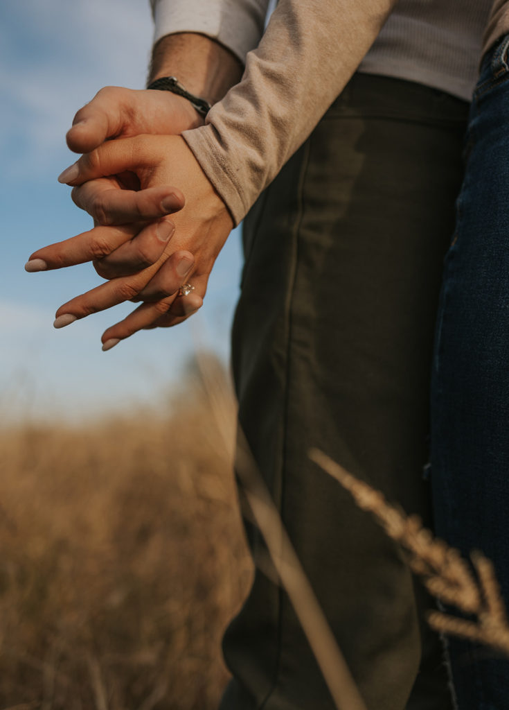 Engagement photo of couple holding hands