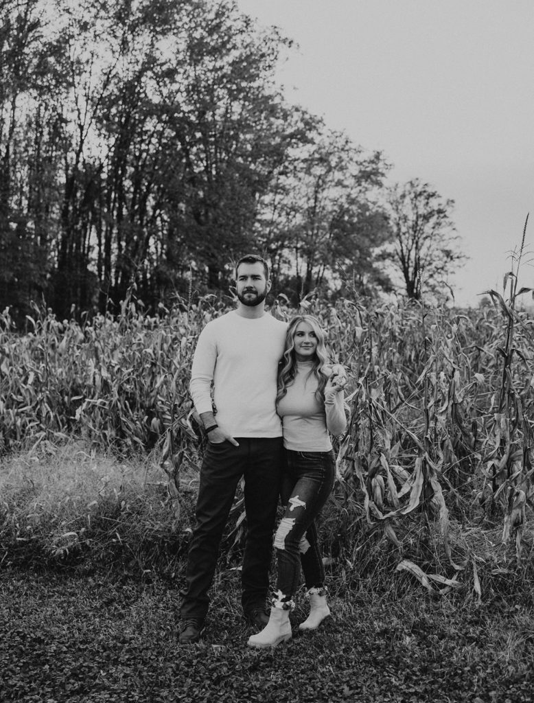 Black and white engagement photo of newly engaged couple in Ohio field