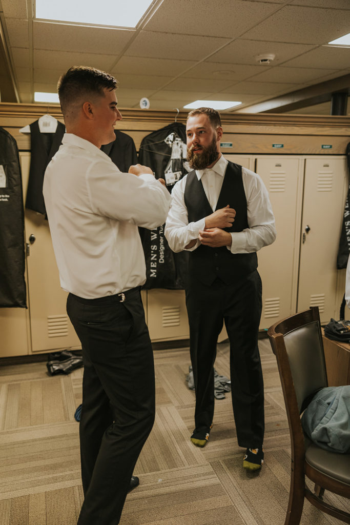 Groom and groomsman getting ready for wedding