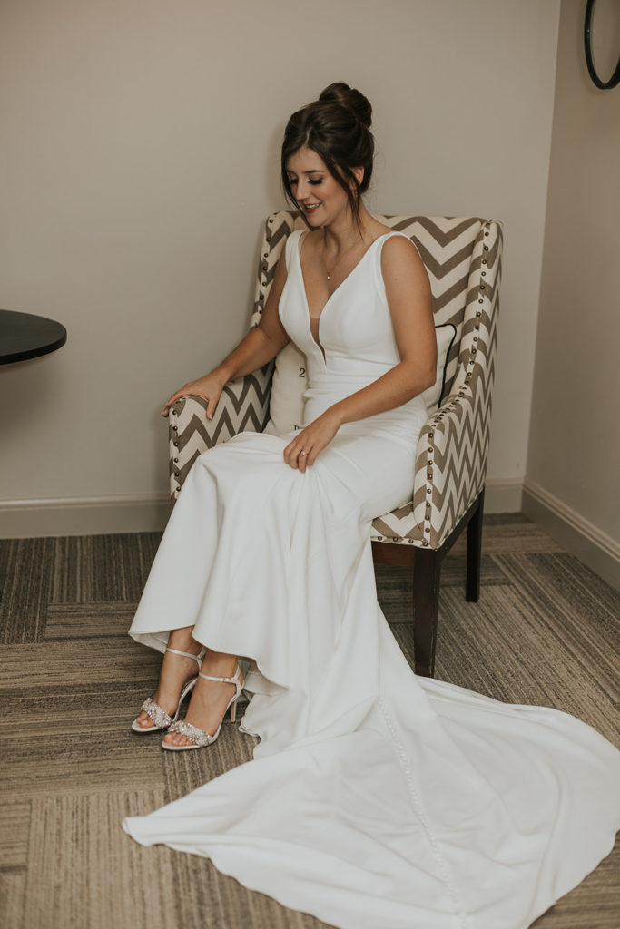 Bride sitting in chair before wedding ceremony