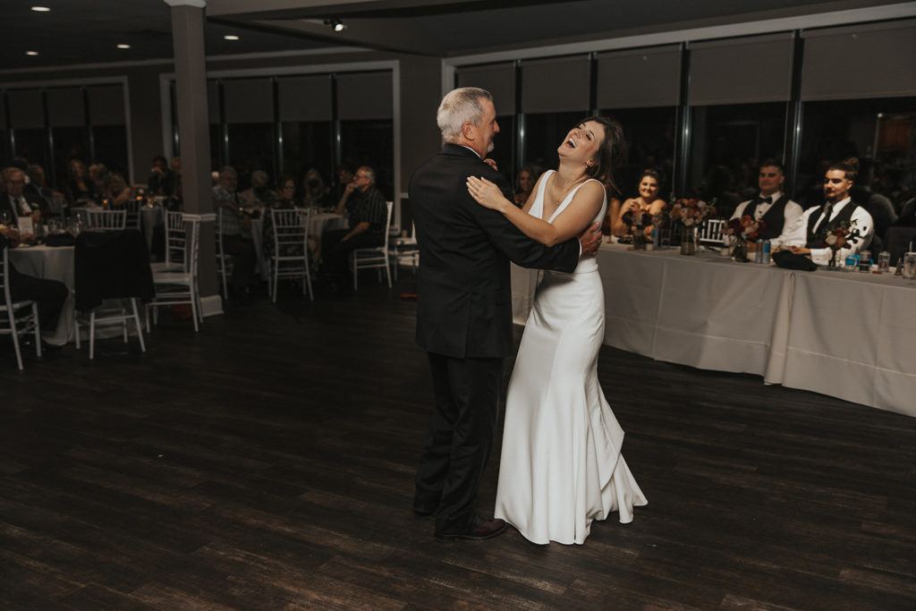 Bride and father of the brides first dance during wedding reception 