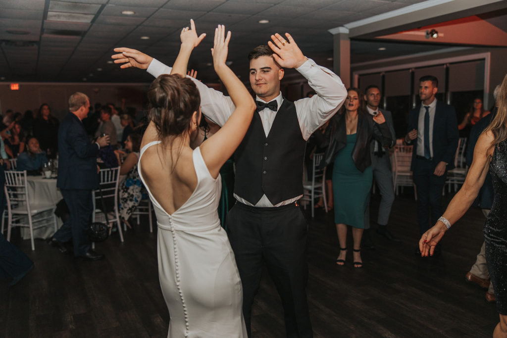Bride and groom dancing at wedding reception 
