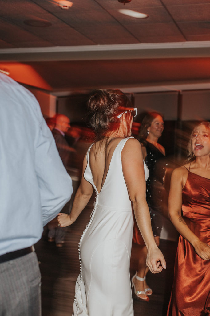 Bride dancing with wedding guest's during wedding reception 